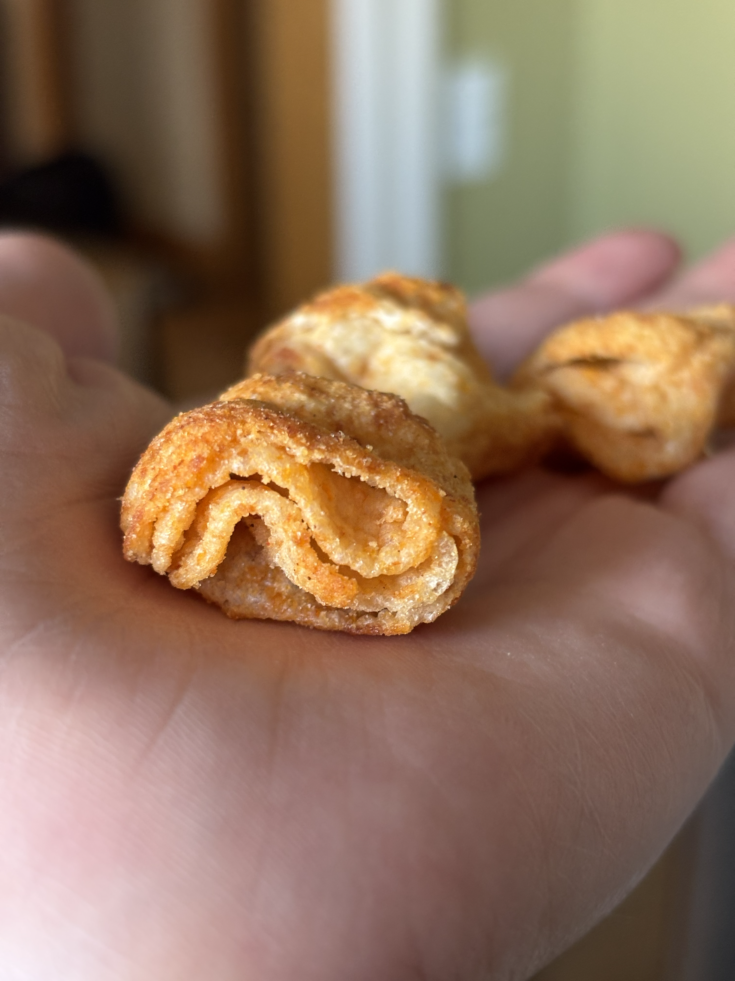 A handful of turtle chips showing off the four crunch layers